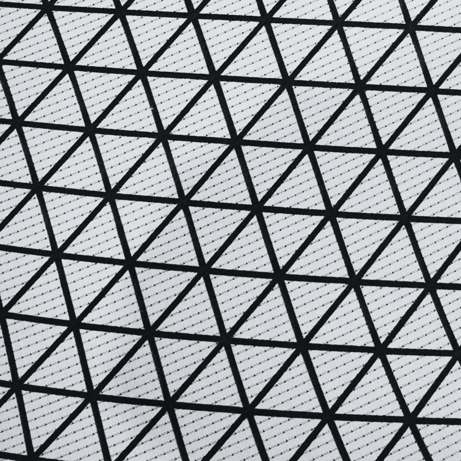 A technical close-up of the high-performance rash guard material showing a breathable black triangular mesh overlaying a grey moisture-wicking fabric.