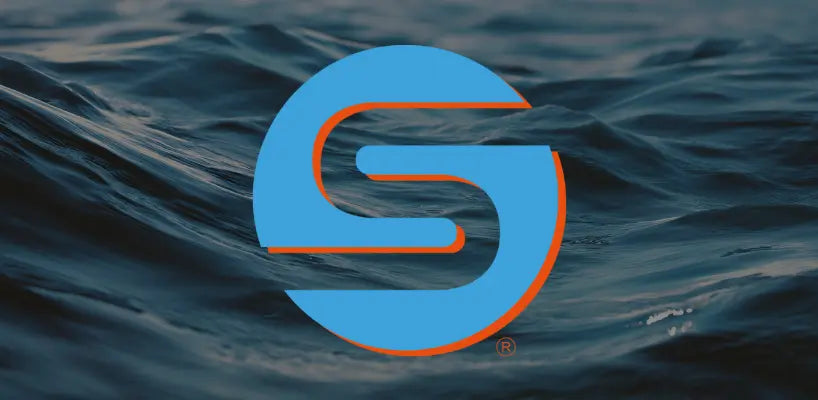 A circular Skild brand logo in blue and orange is centered over a dark, textured background of deep blue ocean waves.